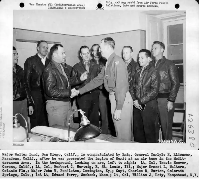 Major Walter Lund, San Diego, Calif., is congratulated by Brig. General Carlyle H. Ridenour, Pasadena, Calif., after he was presented the Legion of Merit at an air base in the Mediterranean Area.