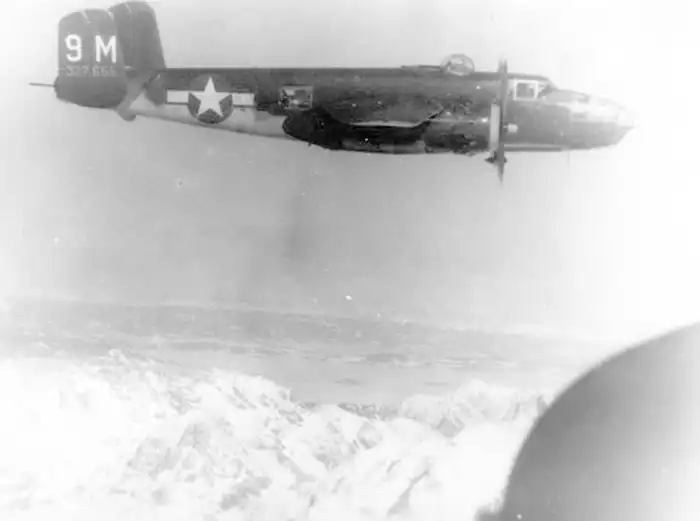 B-25J 9M flying over the Alps. Photograph by Quentin Kaiser.