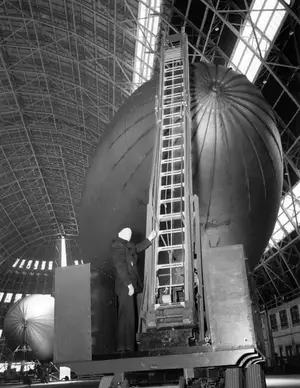 Truck-mounted extension ladder for working on blimps April 7, 1943